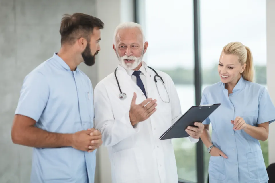 A team of doctors and nurses talking together